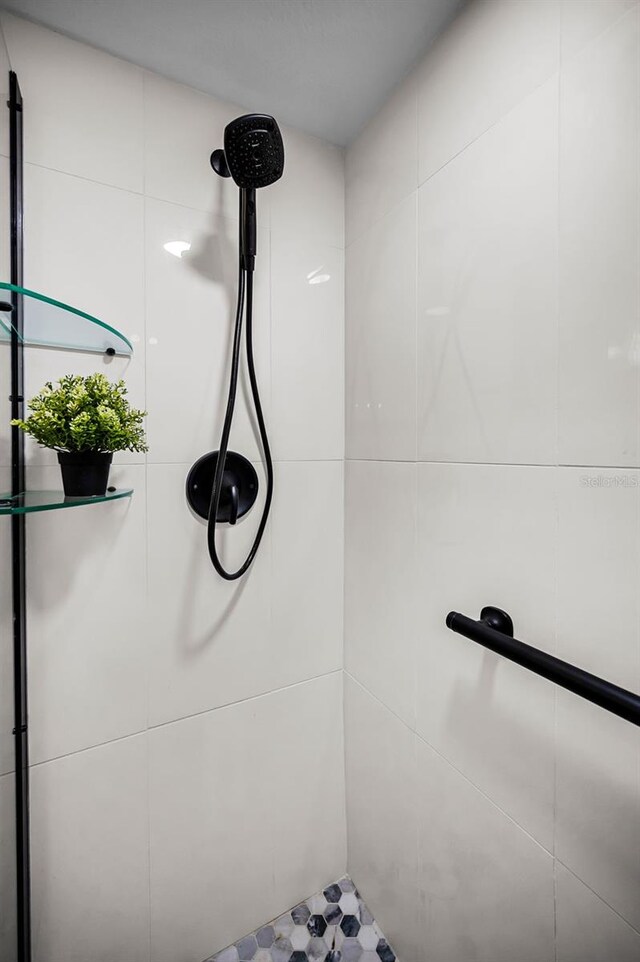 bathroom with a tile shower