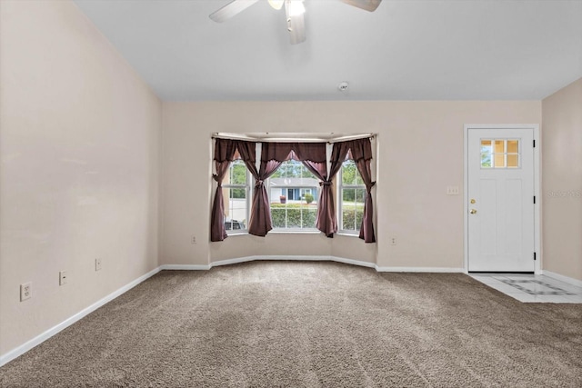 unfurnished room with carpet, ceiling fan, plenty of natural light, and baseboards