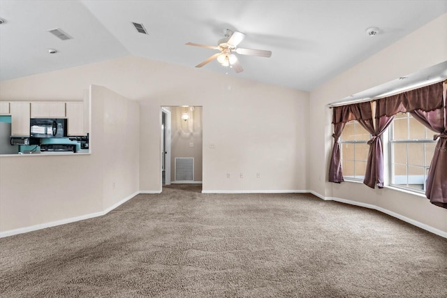 carpeted spare room with lofted ceiling, ceiling fan, and baseboards