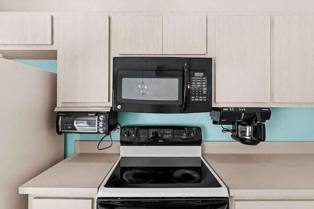 kitchen featuring black microwave, range with electric cooktop, light countertops, and light brown cabinets