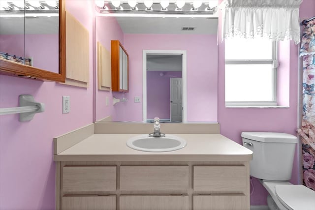bathroom with vanity and toilet