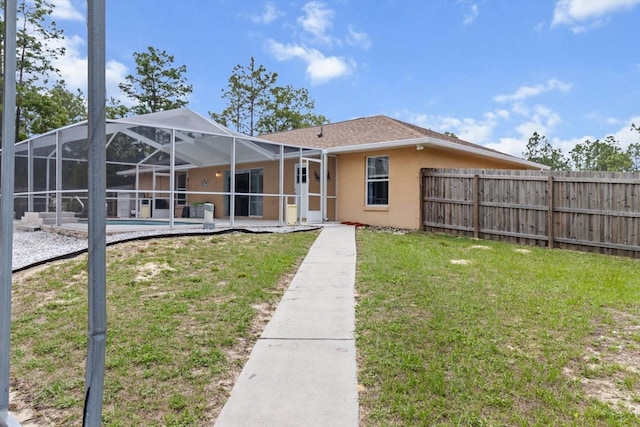 back of house with stucco siding, a patio, and glass enclosure