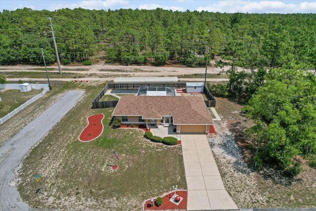 view from above of property with a heavily wooded area
