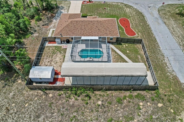 aerial view of property and surrounding area with a pool area