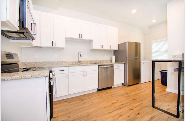 1933 Oxnard Ct, Tampa, FL 33612 - kitchen with appliances with stainless steel finishes, white cabinetry, recessed lighting, light wood-style floors, and light stone countertops