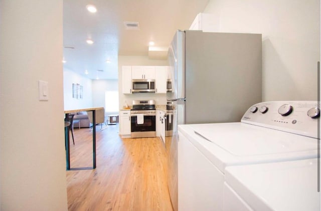 1933 Oxnard Ct, Tampa, FL 33612 - laundry area with washer / dryer, light wood-style floors, and recessed lighting