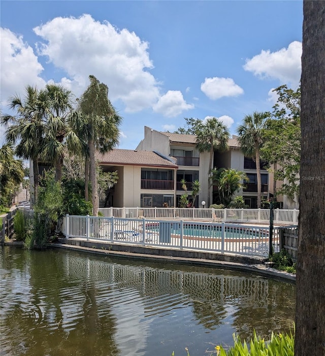 3840 N Lake Dr Unit 125, Tampa, FL 33614 - back of property featuring stucco siding and a community pool