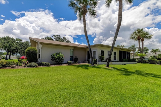 rear view of property with a yard and stucco siding