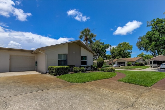 view of front facade with a front lawn, driveway, and a garage