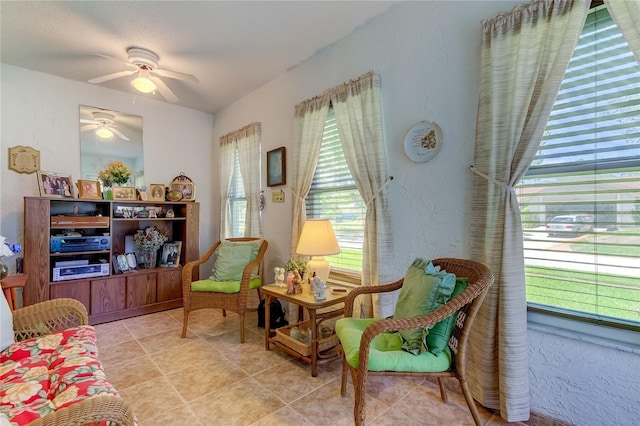 sitting room featuring a ceiling fan