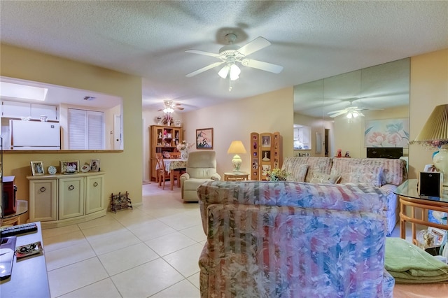 tiled living room featuring ceiling fan and a textured ceiling
