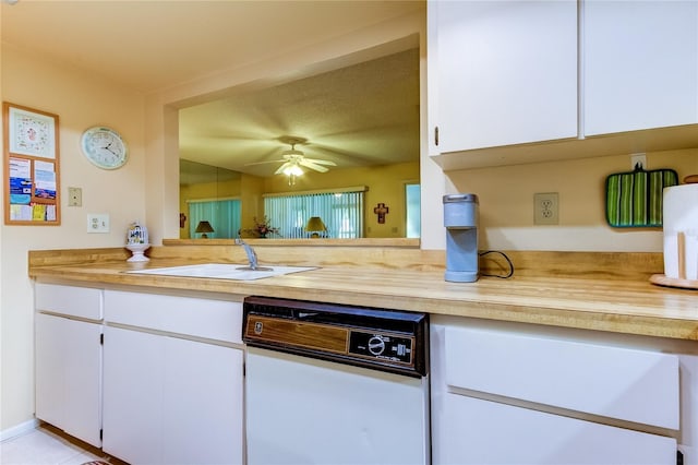 kitchen featuring light countertops, white cabinets, a ceiling fan, dishwasher, and a sink