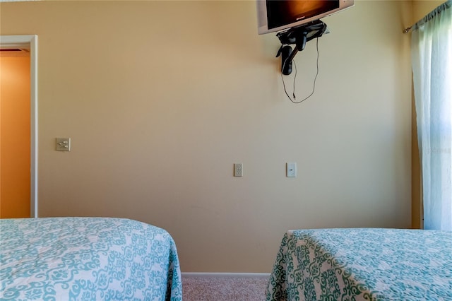 bedroom with carpet flooring and baseboards