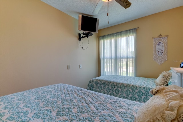 bedroom featuring a textured ceiling and a ceiling fan