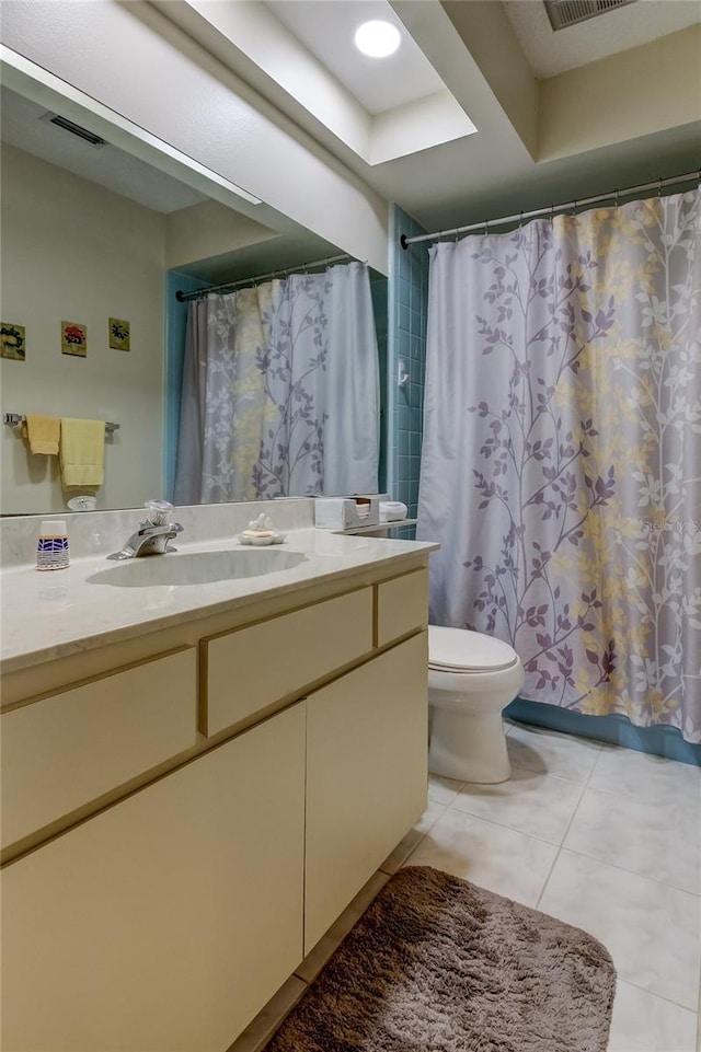 bathroom featuring toilet, vanity, tile patterned flooring, and a shower with shower curtain