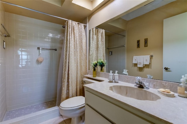 bathroom with toilet, tiled shower, and vanity