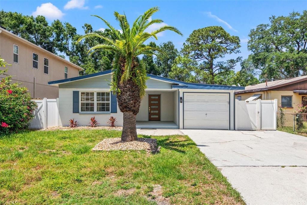 3317 W Iowa Ave, Tampa, FL 33611 - view of front facade with a garage, driveway, and a gate