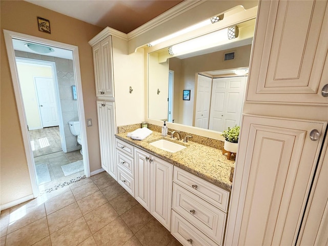 bathroom with tile patterned floors, vanity, toilet, and baseboards