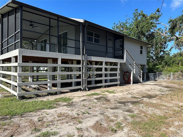 11729 John Robbins Rd, Riverview, FL 33578 - rear view of property featuring stairway, a sunroom, and fence