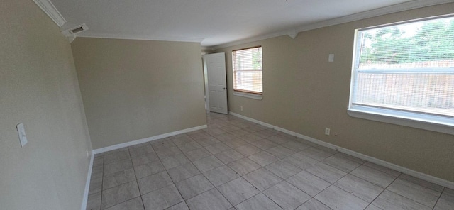 unfurnished room featuring crown molding, light tile patterned flooring, and baseboards