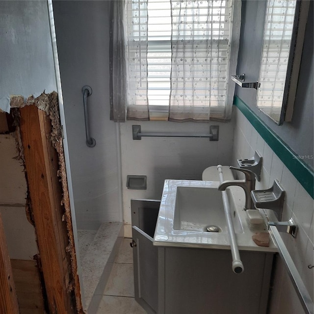319 Boca Ciega Dr, Madeira Beach, FL 33708 - full bathroom featuring a stall shower, tile patterned floors, vanity, and tasteful backsplash