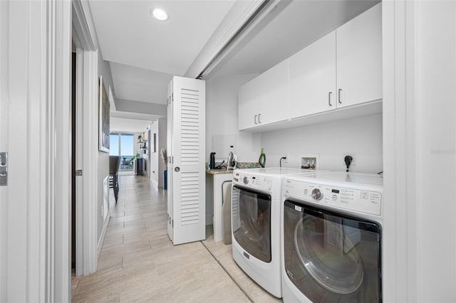 1325 Snell Isle Blvd NE Unit 810, Saint Petersburg, FL 33704 - washroom featuring washer and dryer, cabinet space, light wood-style flooring, recessed lighting, and baseboards