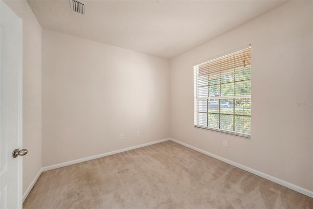 carpeted spare room with baseboards