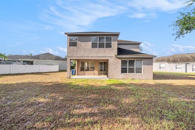 rear view of house with stucco siding and a patio