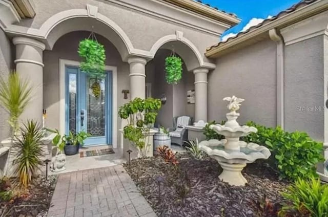 21513 Belvedere Ln, Estero, FL 33928 - doorway to property with stucco siding