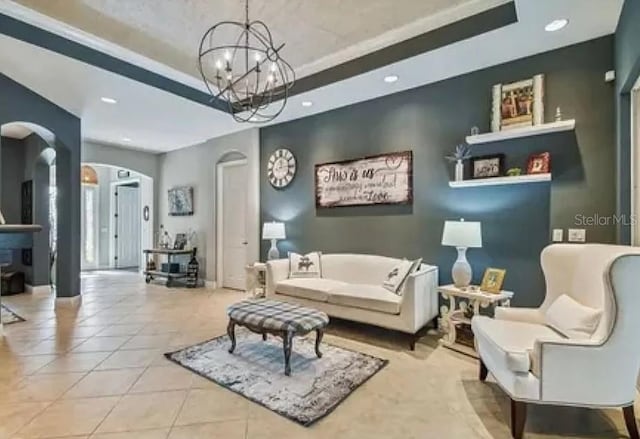 21513 Belvedere Ln, Estero, FL 33928 - tiled living room with arched walkways, a tray ceiling, a chandelier, and recessed lighting