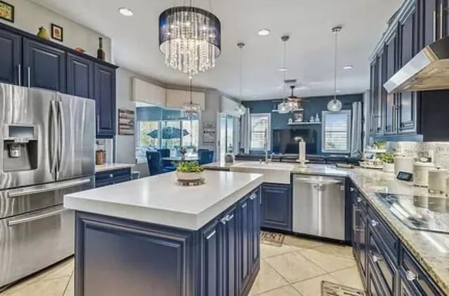 21513 Belvedere Ln, Estero, FL 33928 - kitchen with appliances with stainless steel finishes, blue cabinetry, a chandelier, light countertops, and recessed lighting
