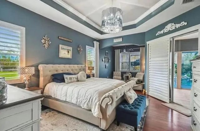 21513 Belvedere Ln, Estero, FL 33928 - bedroom with access to outside, a chandelier, crown molding, wood finished floors, and a raised ceiling