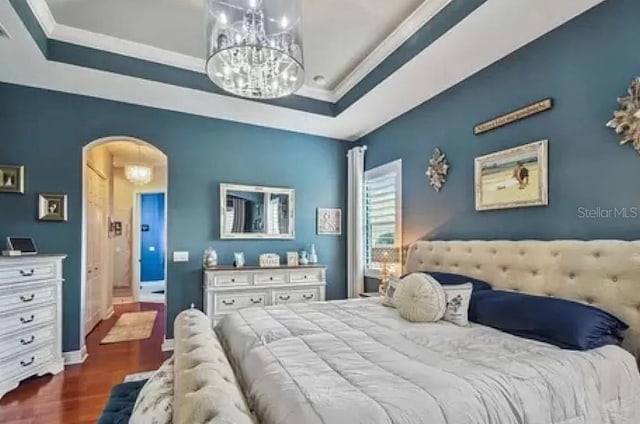 21513 Belvedere Ln, Estero, FL 33928 - bedroom featuring dark wood-type flooring, arched walkways, a tray ceiling, crown molding, and a chandelier