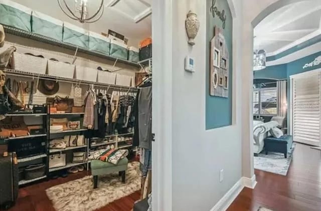 21513 Belvedere Ln, Estero, FL 33928 - interior space featuring arched walkways, wood finished floors, and a chandelier