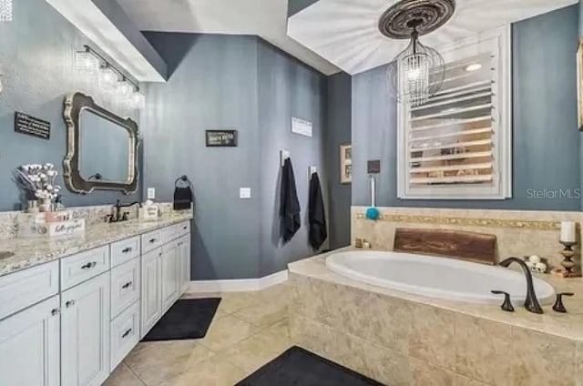 21513 Belvedere Ln, Estero, FL 33928 - bathroom featuring tile patterned floors, a bath, vanity, and baseboards