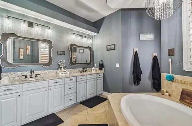 21513 Belvedere Ln, Estero, FL 33928 - bathroom with double vanity, tile patterned floors, a chandelier, and a bath