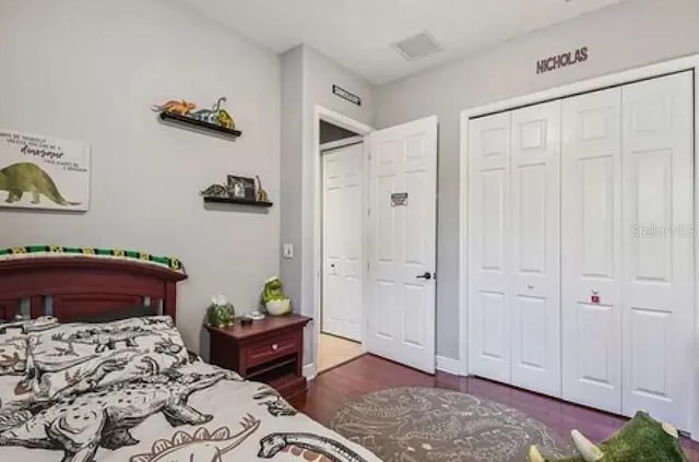 21513 Belvedere Ln, Estero, FL 33928 - bedroom with a closet and dark wood-type flooring