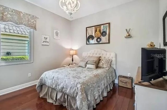21513 Belvedere Ln, Estero, FL 33928 - bedroom with wood finished floors, baseboards, and a chandelier
