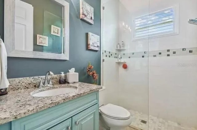 21513 Belvedere Ln, Estero, FL 33928 - bathroom with tiled shower, toilet, and vanity