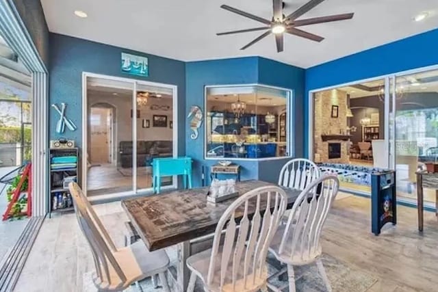 21513 Belvedere Ln, Estero, FL 33928 - dining room featuring ceiling fan, wood finished floors, and arched walkways