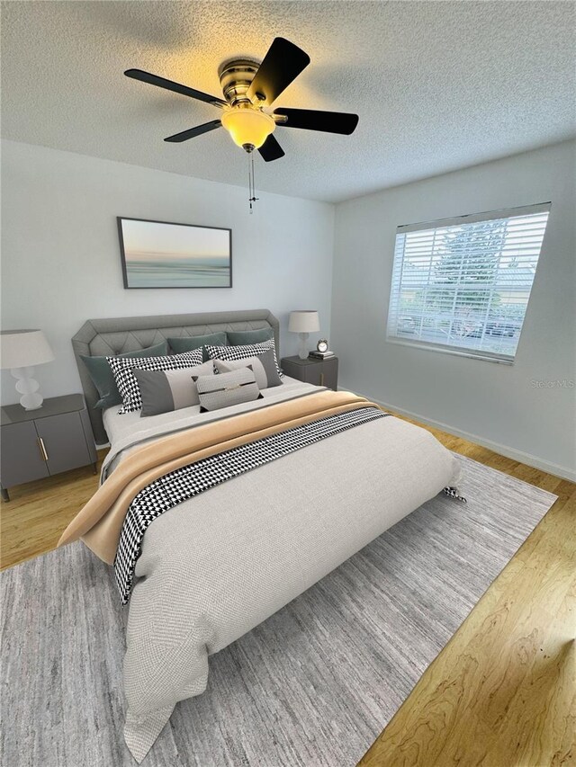 6931 Stones Throw Cir N Unit 5210, Saint Petersburg, FL 33710 - bedroom with wood finished floors, ceiling fan, and a textured ceiling