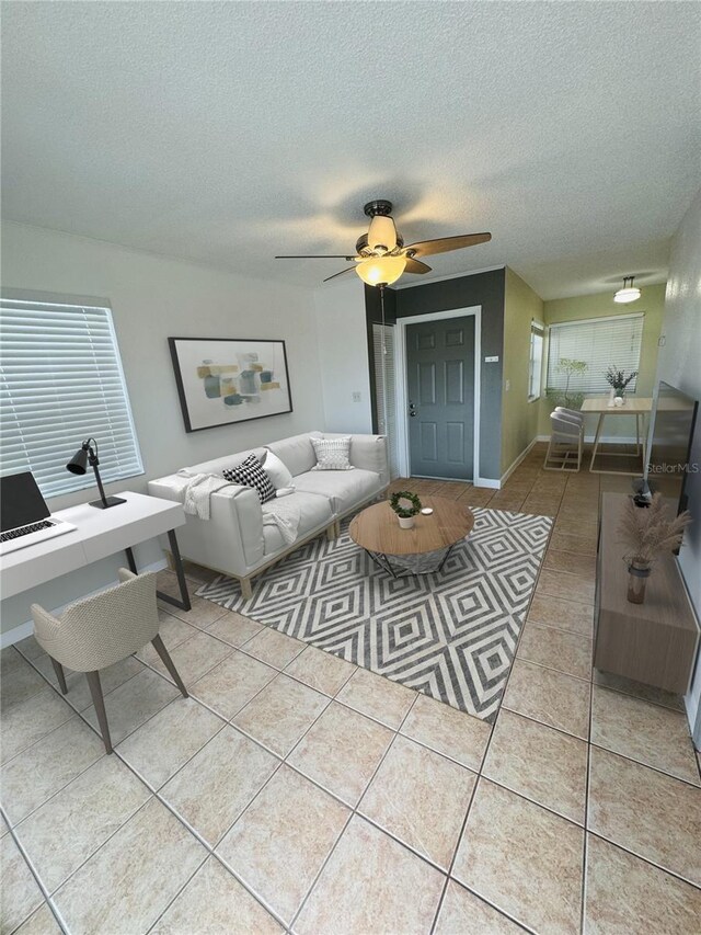 6931 Stones Throw Cir N Unit 5210, Saint Petersburg, FL 33710 - living room featuring tile patterned floors, a textured ceiling, ceiling fan, and an office area