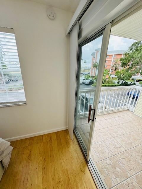 6931 Stones Throw Cir N Unit 5210, Saint Petersburg, FL 33710 - doorway featuring light wood-style floors and baseboards