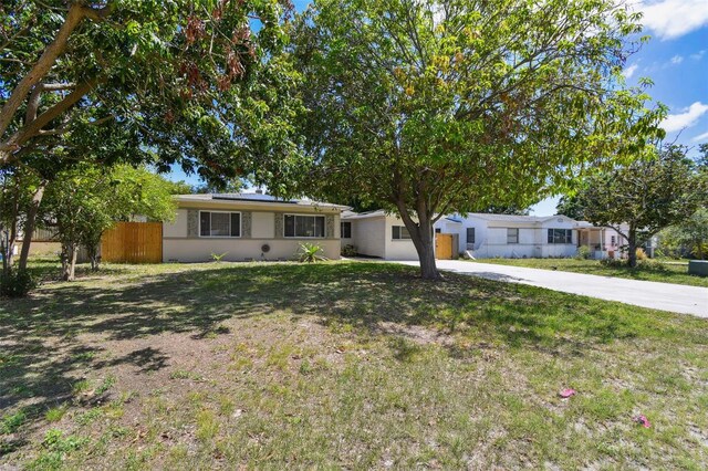 5010 8th Ave N, Saint Petersburg, FL 33710 - ranch-style house with solar panels, driveway, and stucco siding