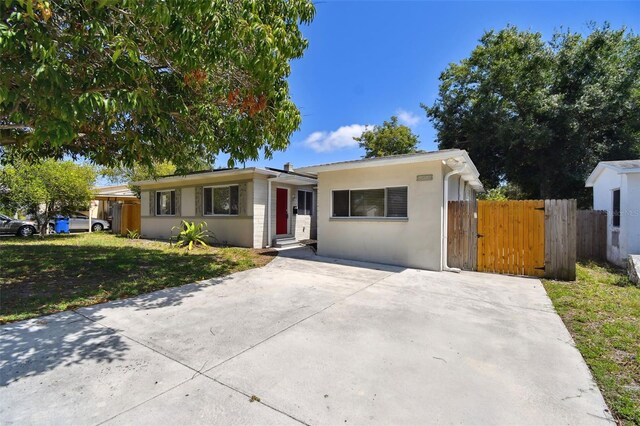 5010 8th Ave N, Saint Petersburg, FL 33710 - ranch-style home with a gate and stucco siding