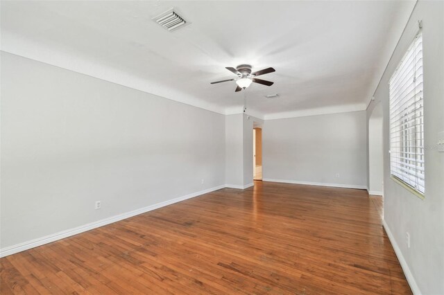 5010 8th Ave N, Saint Petersburg, FL 33710 - empty room featuring ceiling fan, plenty of natural light, and wood finished floors