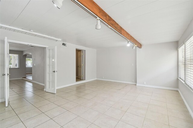 5010 8th Ave N, Saint Petersburg, FL 33710 - empty room featuring rail lighting, french doors, arched walkways, and light tile patterned floors