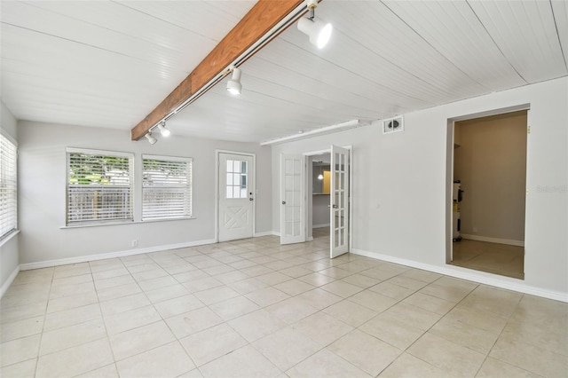 5010 8th Ave N, Saint Petersburg, FL 33710 - empty room with rail lighting, healthy amount of natural light, and baseboards