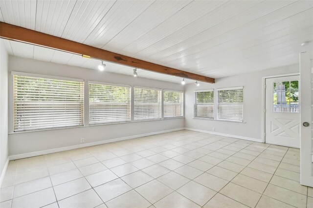 5010 8th Ave N, Saint Petersburg, FL 33710 - unfurnished sunroom with baseboards, beamed ceiling, and tile patterned flooring
