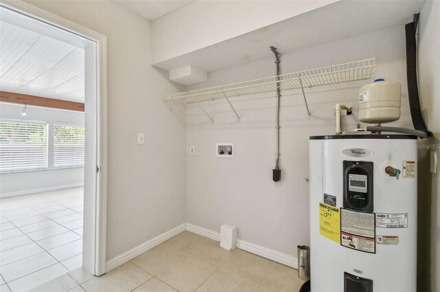 5010 8th Ave N, Saint Petersburg, FL 33710 - laundry area with electric water heater, hookup for a washing machine, baseboards, and light tile patterned floors
